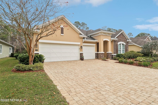 view of front of home featuring a garage and a front lawn