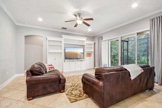 living room featuring ceiling fan, light tile patterned floors, and crown molding