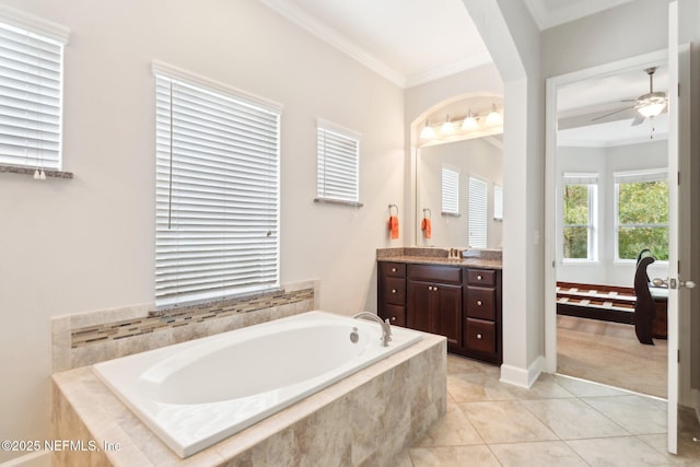 bathroom featuring ceiling fan, vanity, tile patterned flooring, tiled bath, and ornamental molding