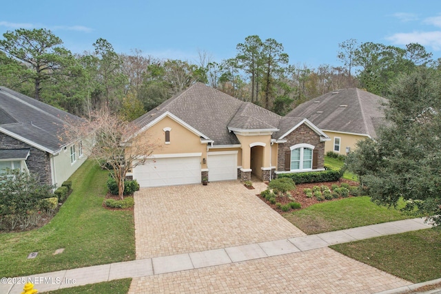 ranch-style home featuring a front lawn and a garage