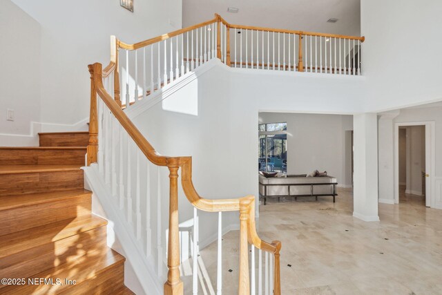 staircase featuring a high ceiling