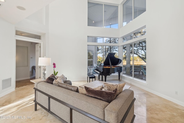 living room with a towering ceiling