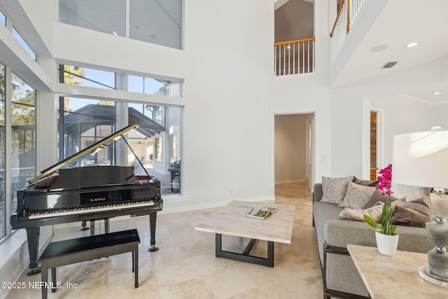 living room featuring a towering ceiling