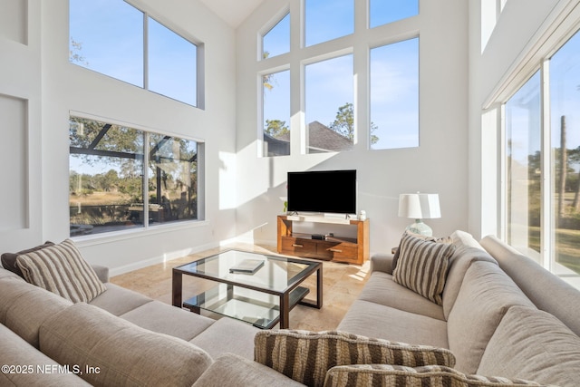 living room with a towering ceiling and a wealth of natural light