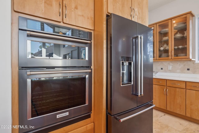 kitchen with decorative backsplash and stainless steel appliances