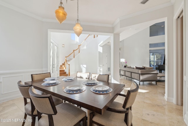 dining room with crown molding and light tile patterned floors