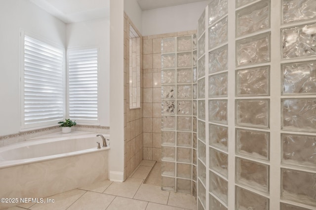 bathroom with tile patterned floors and independent shower and bath