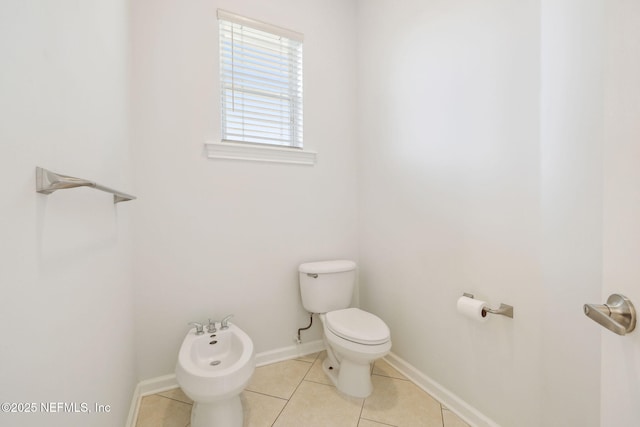 bathroom featuring a bidet, tile patterned floors, and toilet