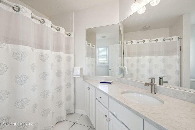 bathroom featuring curtained shower, tile patterned flooring, and vanity