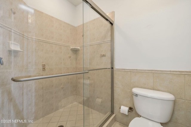 bathroom featuring an enclosed shower and toilet