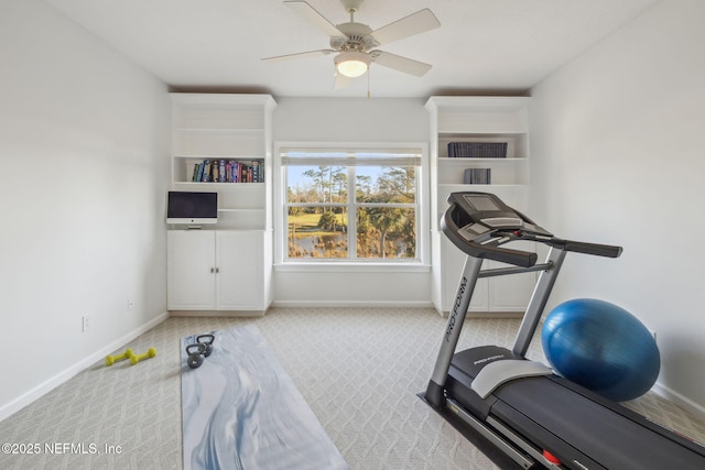 exercise room featuring light colored carpet and ceiling fan