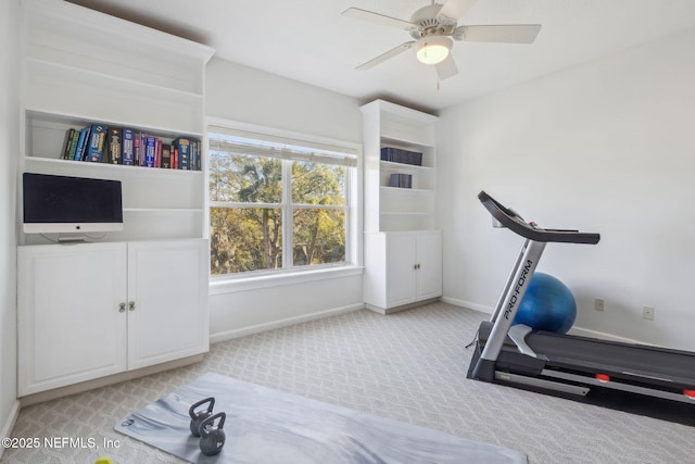 exercise room featuring light colored carpet and ceiling fan