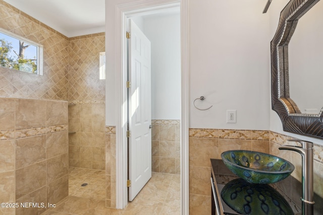 bathroom with sink and tile walls