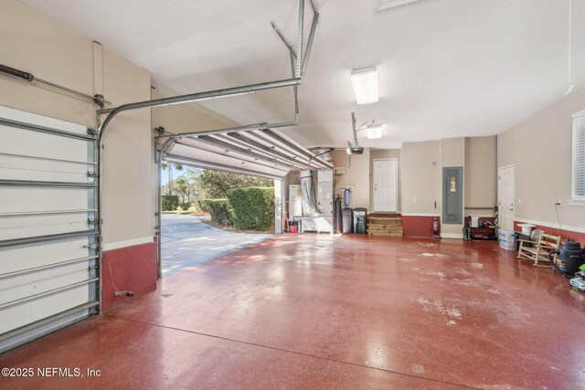 garage with electric panel and a garage door opener