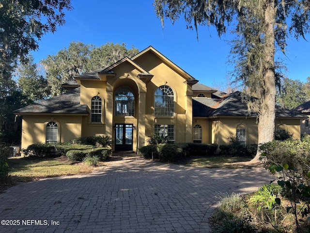 mediterranean / spanish-style home with french doors