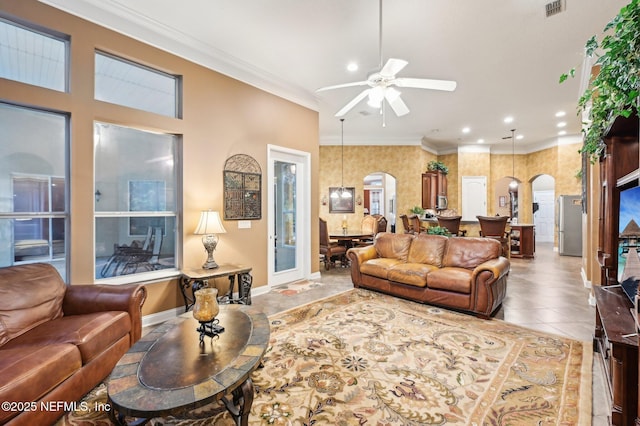 tiled living room featuring crown molding and ceiling fan