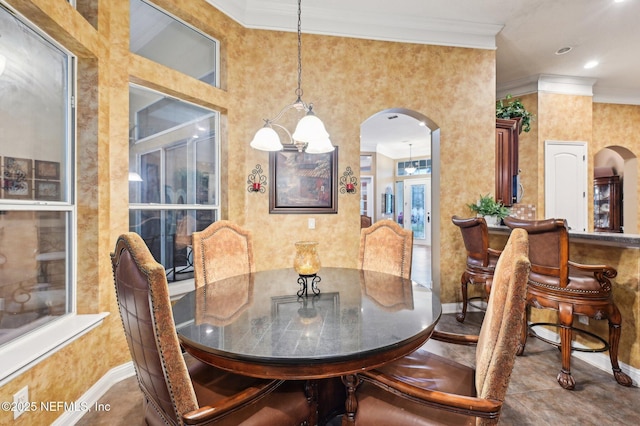 dining space with ornamental molding