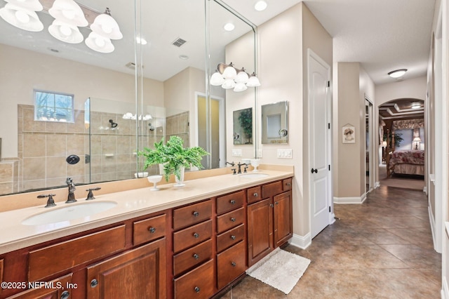 bathroom with vanity and a tile shower