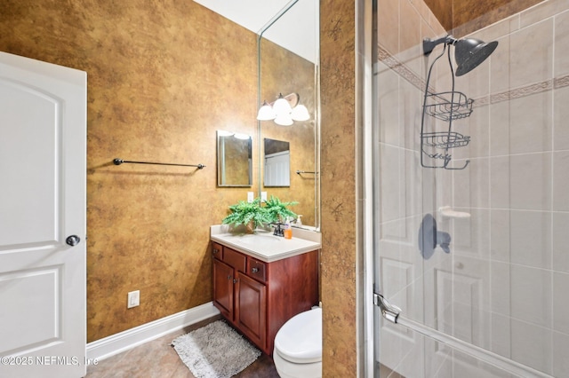 bathroom with vanity, toilet, and an enclosed shower