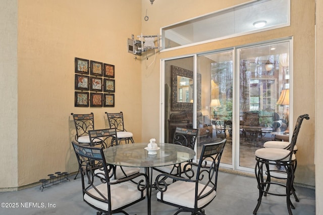 dining space featuring concrete flooring