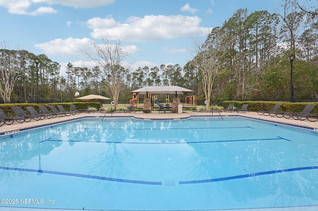 view of pool featuring a playground