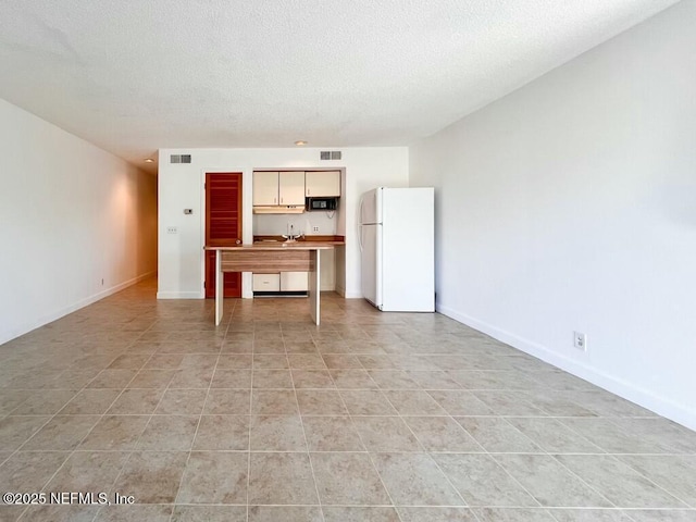 unfurnished living room featuring a textured ceiling