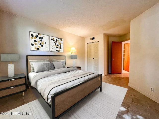 tiled bedroom featuring a closet