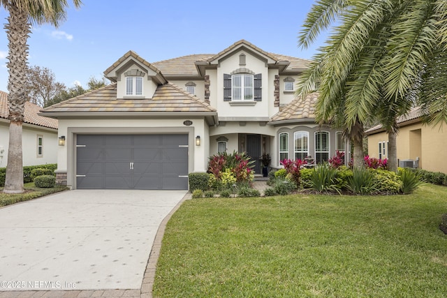 view of front of home with a garage and a front lawn