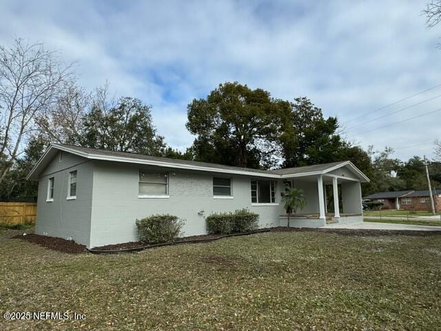 ranch-style house with covered porch and a front lawn