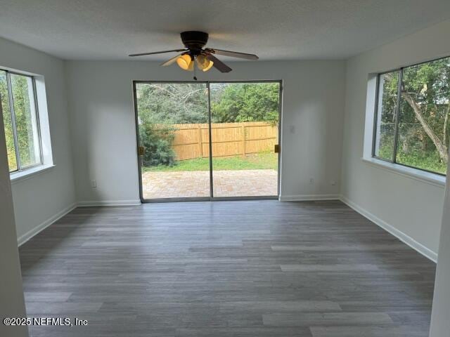 spare room with ceiling fan and dark wood-type flooring