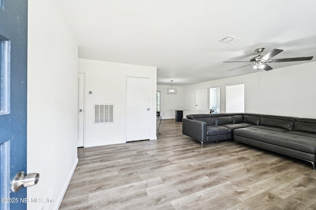 living room featuring ceiling fan and light wood-type flooring