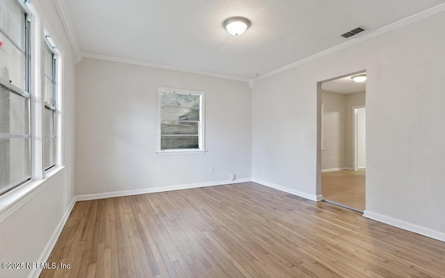 unfurnished room with light wood-type flooring and crown molding