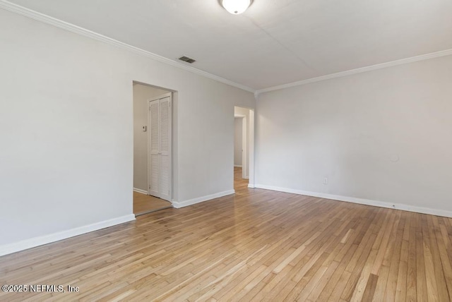 unfurnished room with light wood-type flooring and crown molding