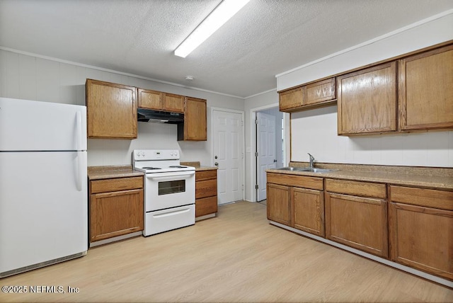 kitchen featuring a textured ceiling, white appliances, light hardwood / wood-style floors, and sink