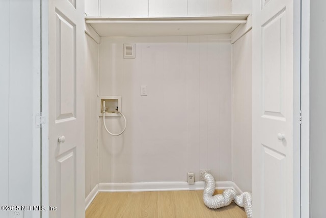 laundry area with hookup for a washing machine and light hardwood / wood-style floors