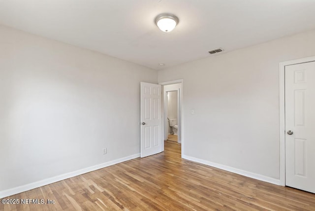 unfurnished room with light wood-type flooring