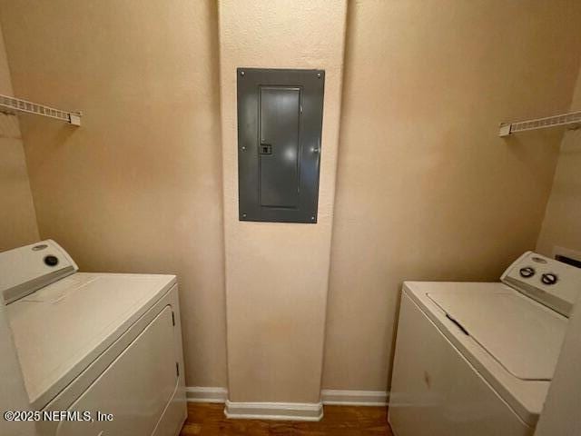 washroom featuring electric panel and washer and clothes dryer