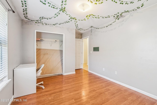 unfurnished office featuring hardwood / wood-style floors