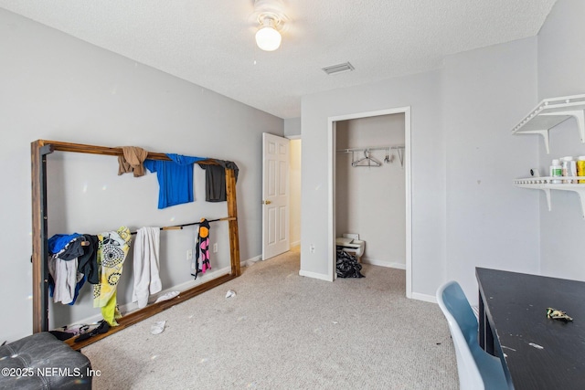 carpeted bedroom featuring a textured ceiling and a closet