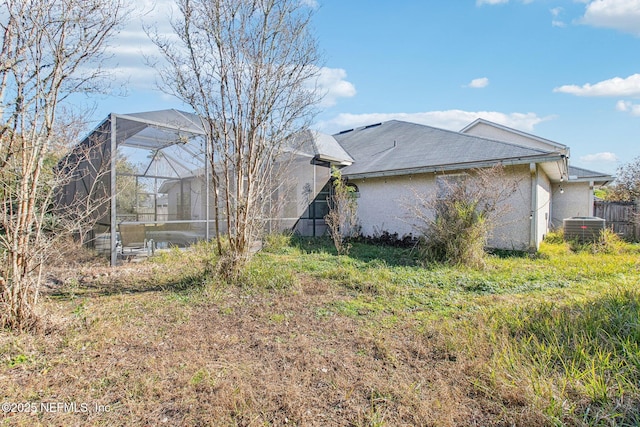 view of property exterior with a lanai and central AC