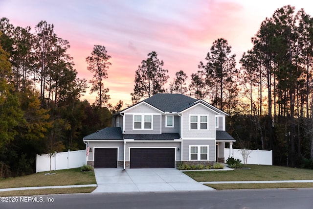 view of front of property featuring a garage and a yard