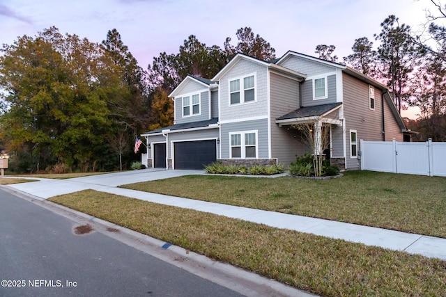 view of front facade with a garage and a lawn