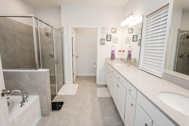 bathroom featuring plus walk in shower, vanity, and tile patterned flooring