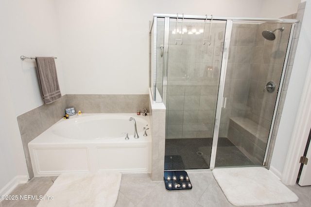 bathroom featuring tile patterned floors and separate shower and tub