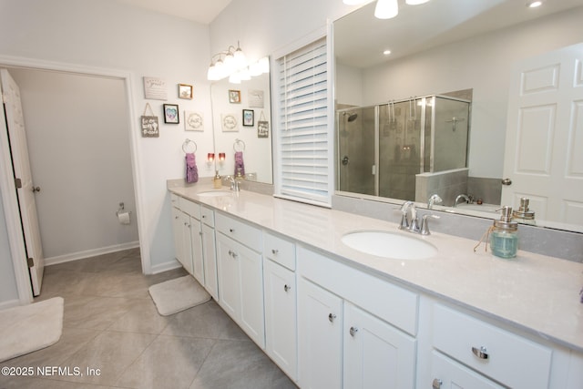 bathroom with tile patterned flooring, vanity, and walk in shower