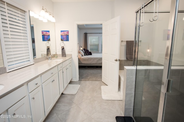 bathroom featuring tile patterned floors, vanity, and a shower with shower door