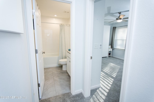 bathroom featuring ceiling fan, shower / bath combination with curtain, and toilet