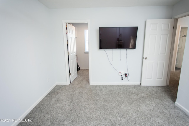 unfurnished bedroom featuring light carpet