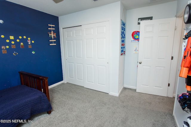 bedroom featuring a closet and light colored carpet