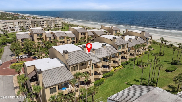 birds eye view of property with a view of the beach and a water view